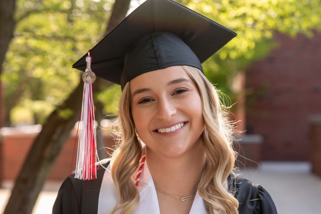 college graduate in the spring with sun behind her