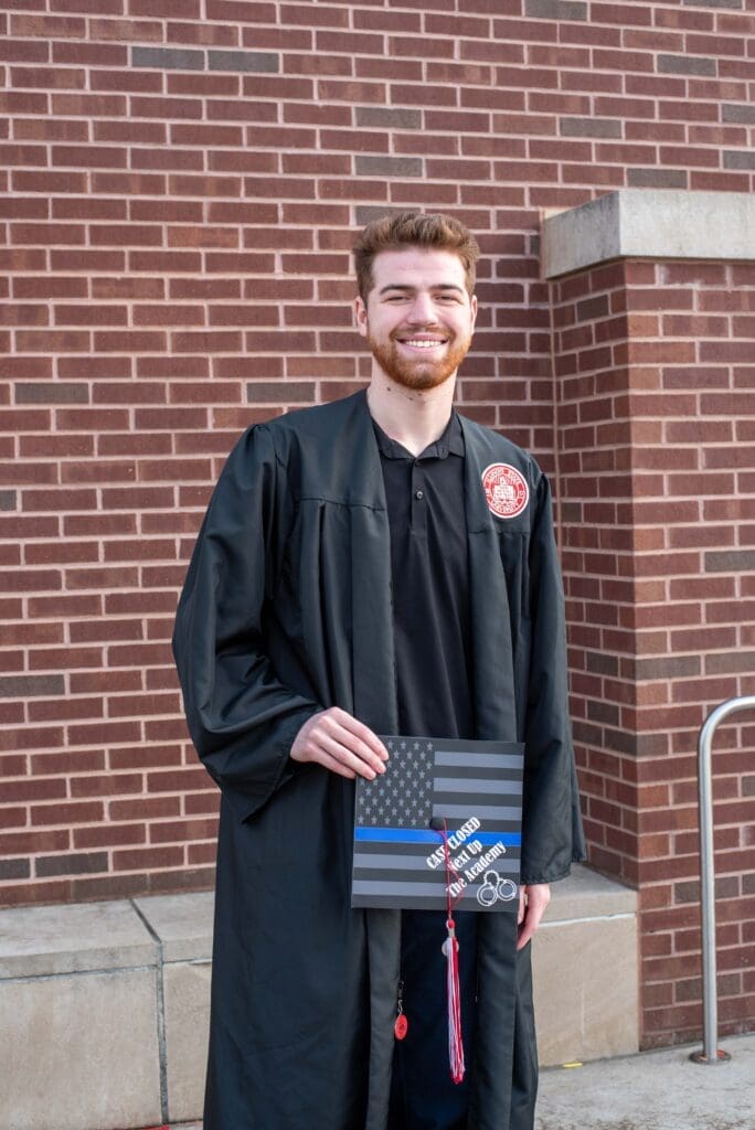 college guy graduation gown and decorated cap