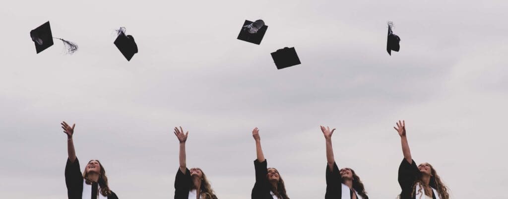 graduation caps thrown in the air by high school seniors